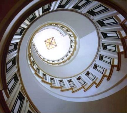 Spiral staircase viewed from below — architectural photography